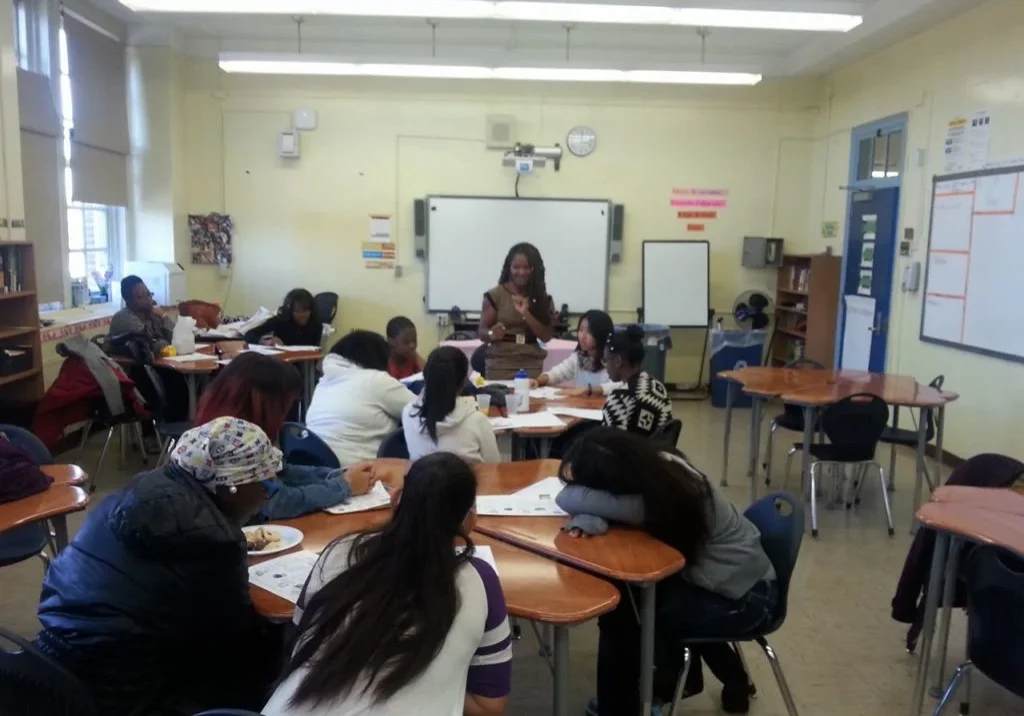Students and teacher in a classroom setting.